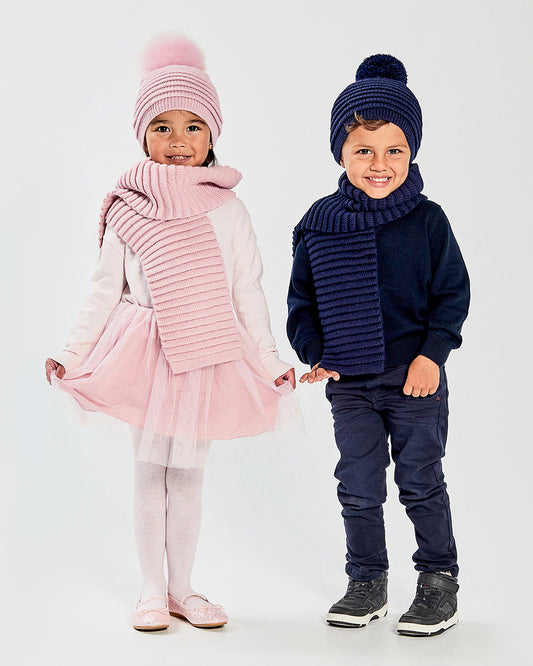 Sentaler Kids Ribbed Pink Hat with Fur Pompon (4-5 Years) and Kids Ribbed Pink Scarf (4-5 Years) in Baby Alpaca yarn. Seen from front on girl model.
